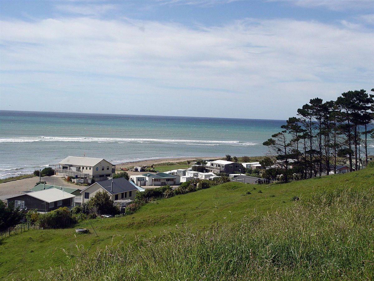The Akitio settlement and camping ground above the break, Ākitio surf spot, Wellington / Wairarapa, New Zealand.