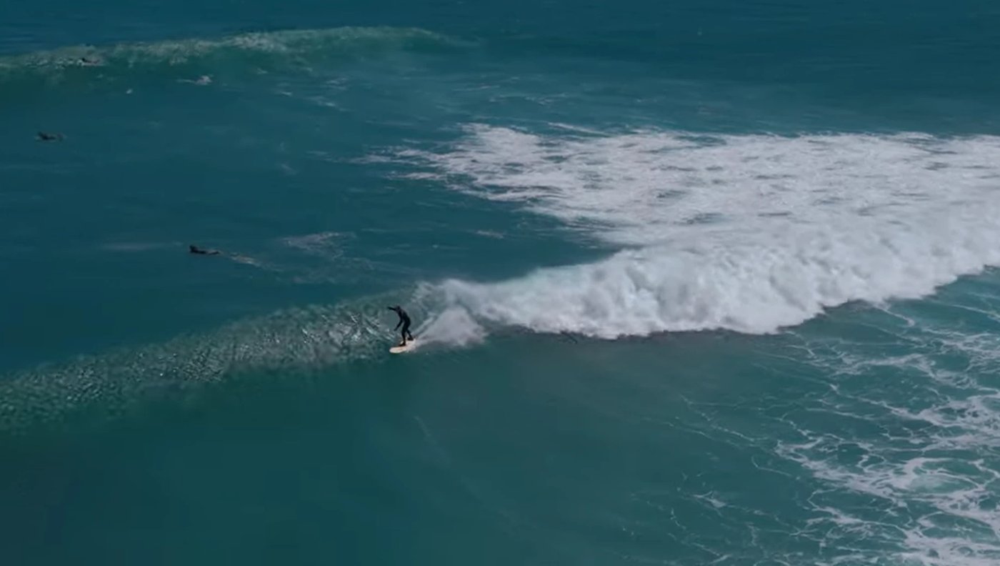 A surfer riding a clean wall at Arawhata Road on the South Taranaki coast, Arawhata Rd surf spot, Taranaki / SH45, New Zealan