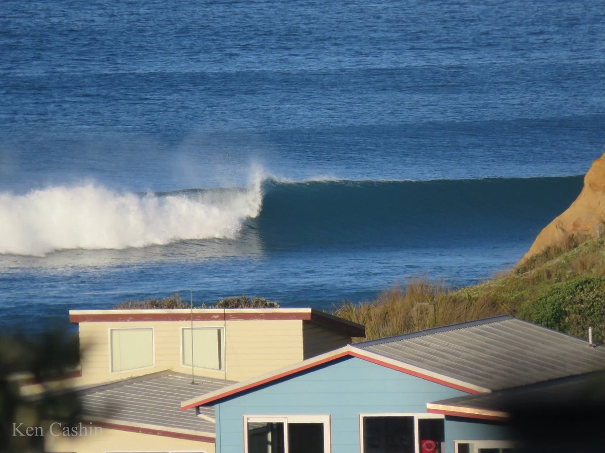 A clean Tasman swell wrapping in at the cliffs, Baylys Beach surf spot, Northland West, New Zealand.