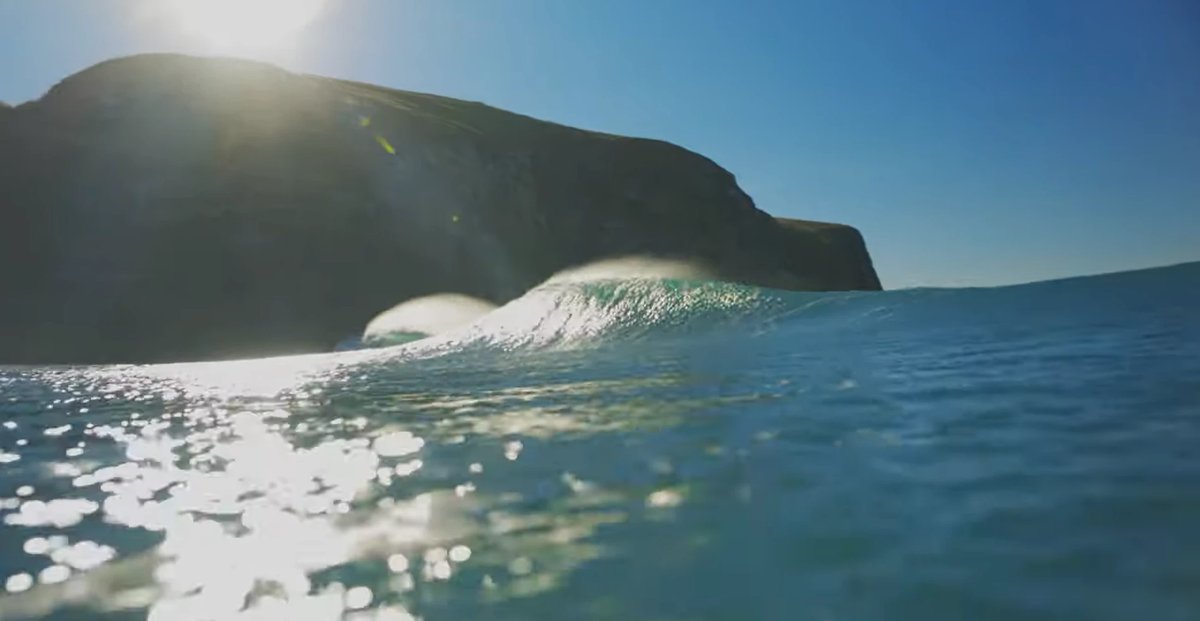 A glassy peak feathers off the point, the sun flaring over the headland that hoovers up the swell, Hickory Bay surf spot, Can