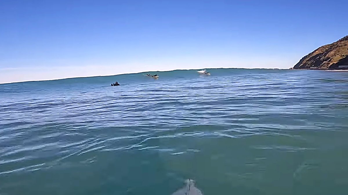 Eyeing up a set from the water as it wraps in around the point, Mangamaunu surf spot, Kaikoura / North Canterbury, New Zealan
