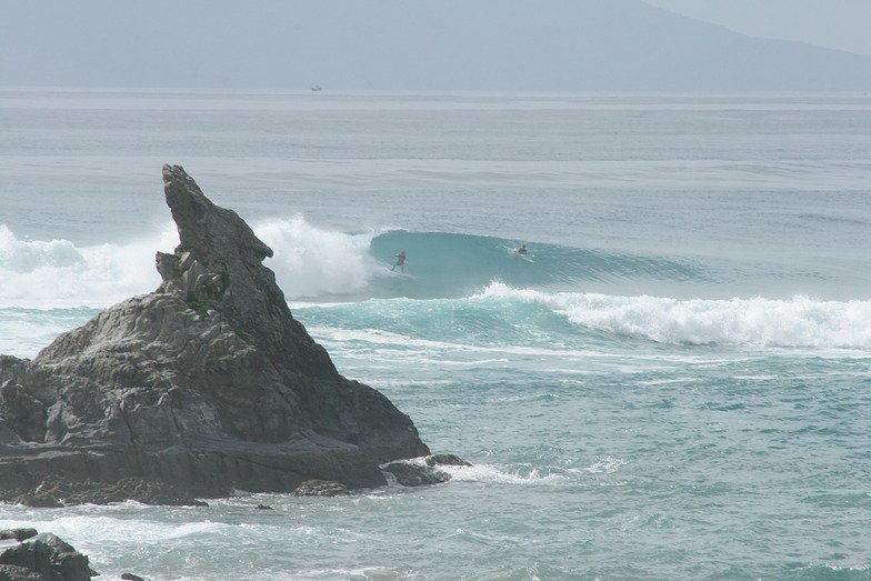 Into the pit beside the rock at the bar, Mangawhai surf spot, Northland East, New Zealand.