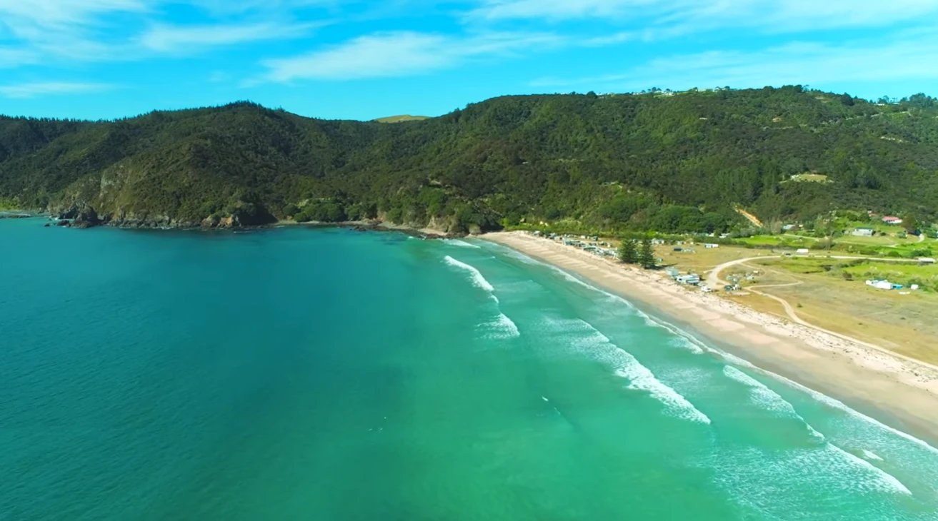 Looking down the bay from the air, turquoise water all the way out to the Cavallis, Matauri Bay surf spot, Northland East, Ne