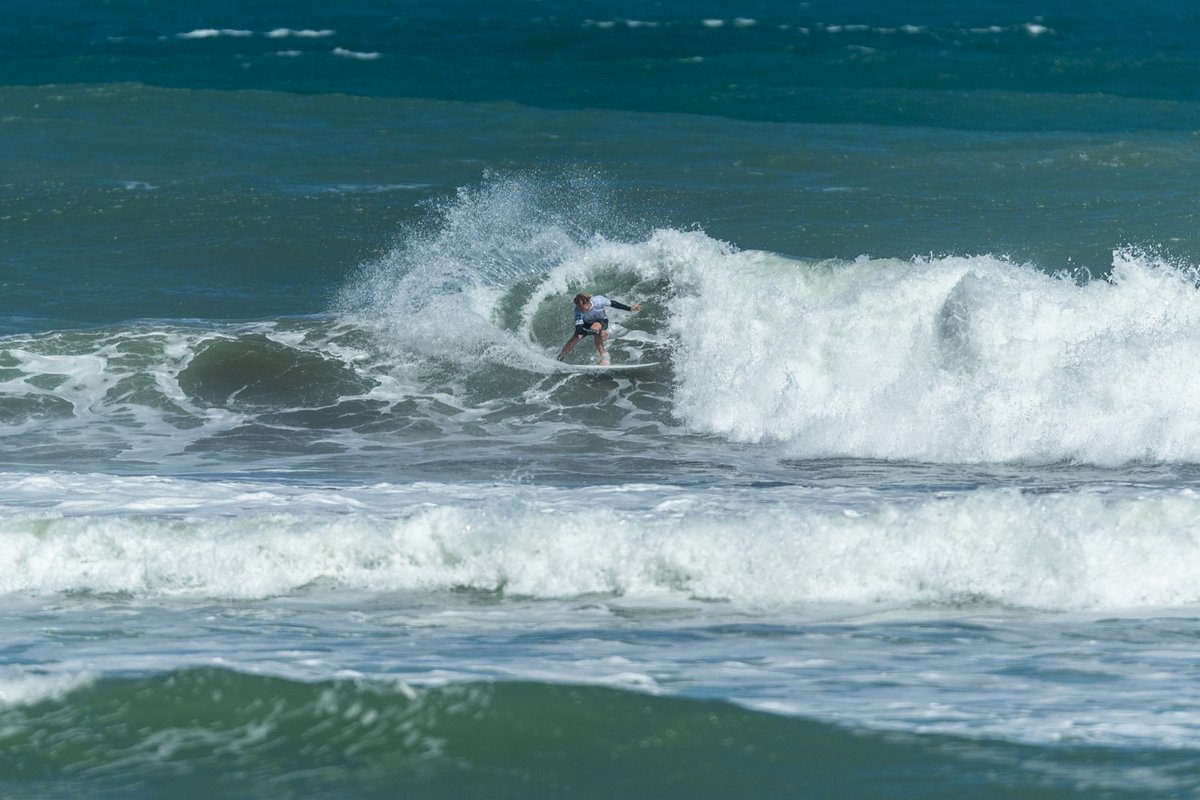 Carving on a punchy west coast peak, Muriwai surf spot, Auckland West, New Zealand.