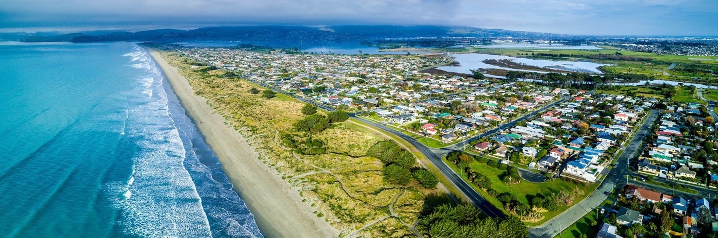 New Brighton stretched along the dunes between the open Pacific and the Avon-Heathcote estuary, Christchurch's everyday surf 