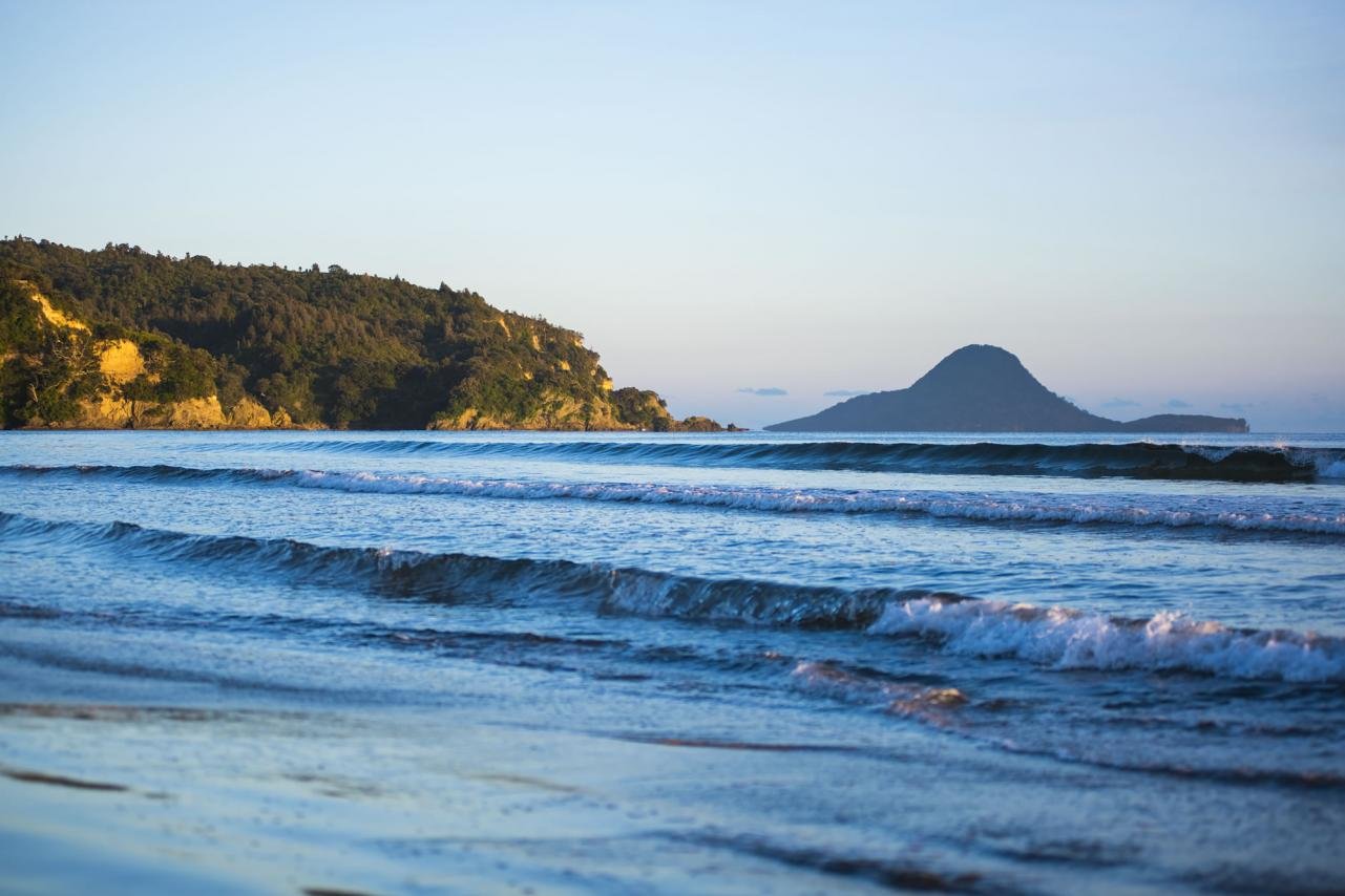 First light at Ōhope with Moutohorā (Whale Island) silhouetted offshore. One of the most photographed surf beach views in New