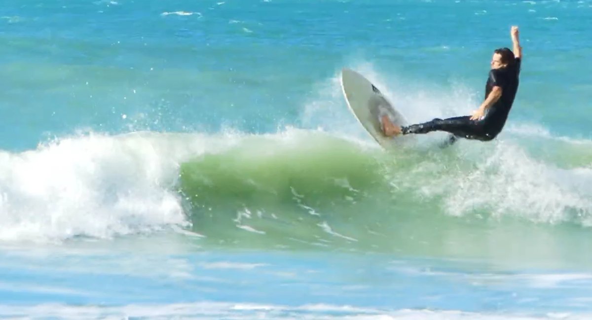 A surfer carving on a rare cyclone swell, Onetangi (Waiheke) surf spot, Auckland / Rodney, New Zealand.