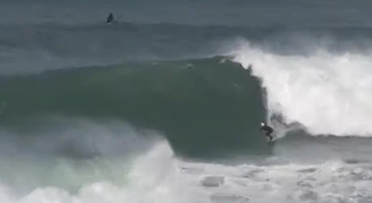 A late drop under a thick lip as a paddler scrambles over the top, Papatowai showing its serious side, Papatowai surf spot, C