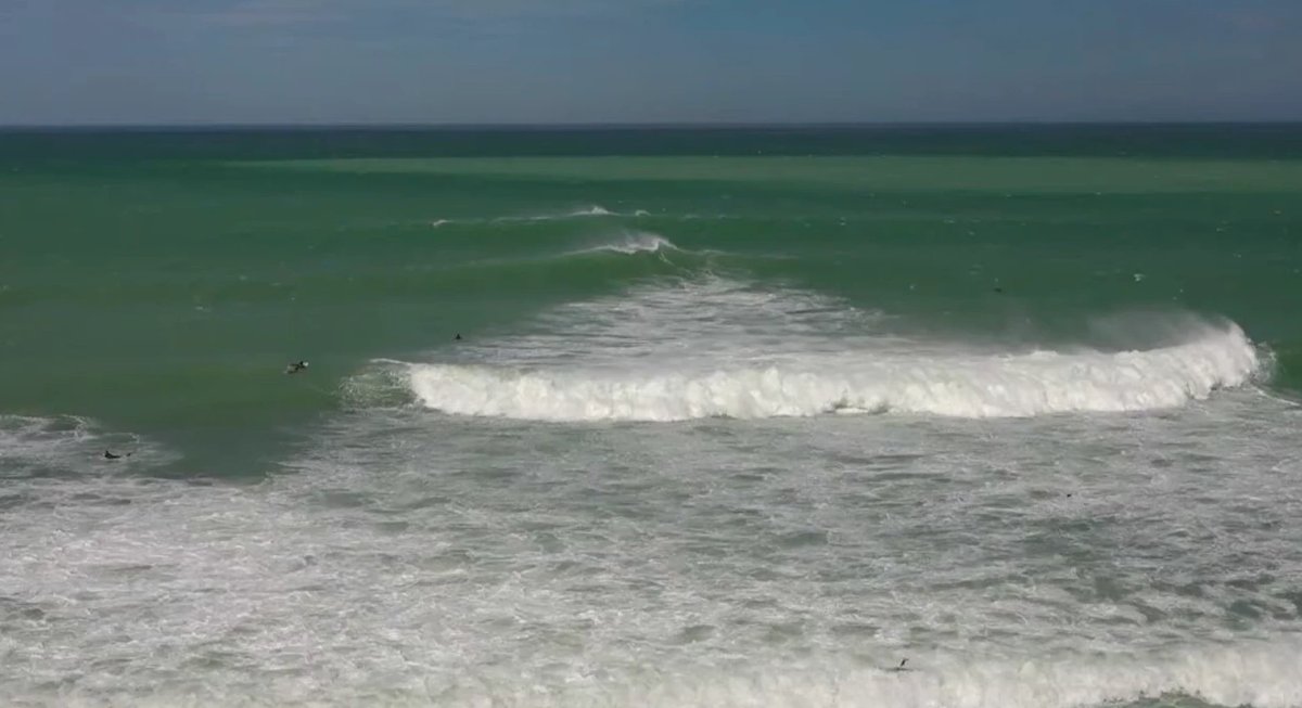 Sets pushing through the lineup, a couple of locals working the peaks off the point, Patiti Pt / Timaru surf spot, Canterbury