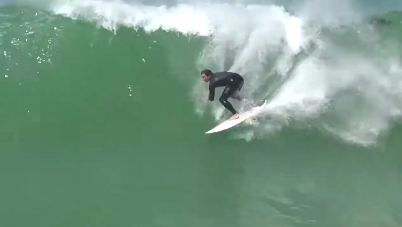 Driving down a clean green wall off the point, Timaru's home break showing its steep, fast face, Patiti Pt / Timaru surf spot