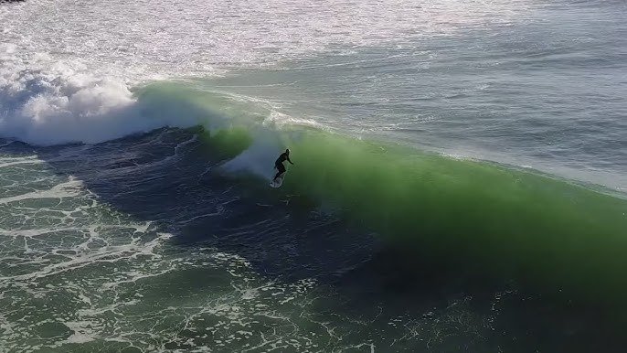 Drop into a clean green Indies wall. The takeoff is heavier than Manu, the wave pitches sharply and demands real commitment, 