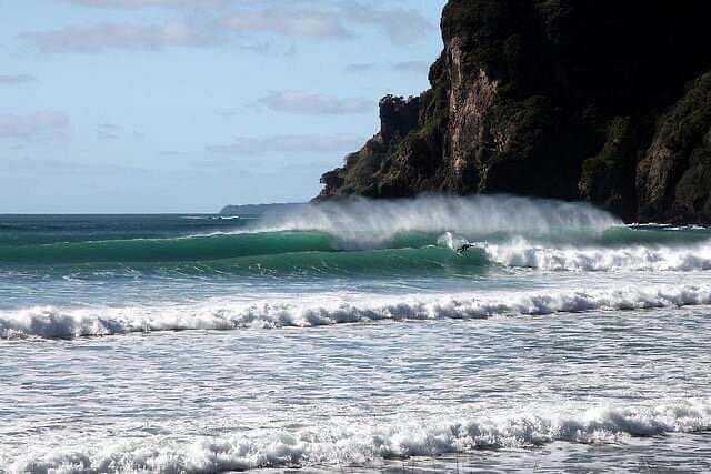 South point lining up on a clean NE swell, Taupo Bay surf spot, Northland East, New Zealand.