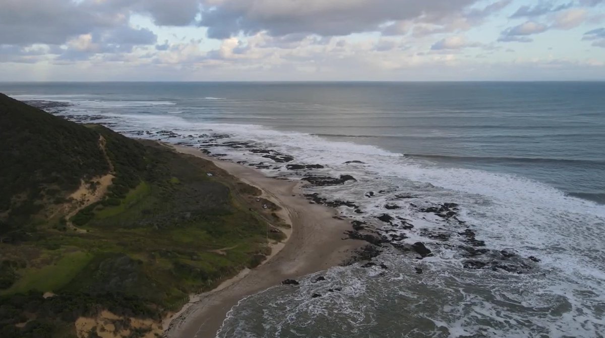 Wider view of the rocky coast on a bigger day, Tauroa / Shipwreck Bay surf spot, Northland West, New Zealand.