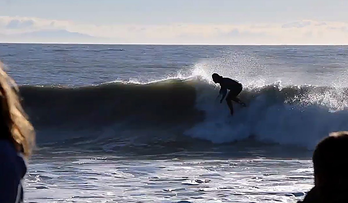 Setting the rail on a clean one as the swell finally lines up on the shingle bar, The Cut (Blenheim) surf spot, Marlborough /