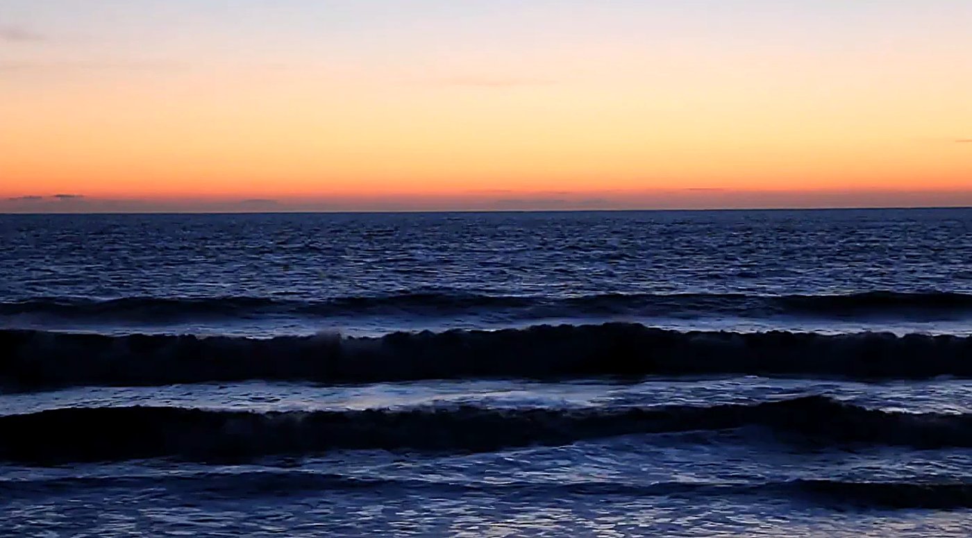 Lines of swell roll into the shingle at dusk, the Marlborough sky going soft orange over Cloudy Bay, The Cut (Blenheim) surf 